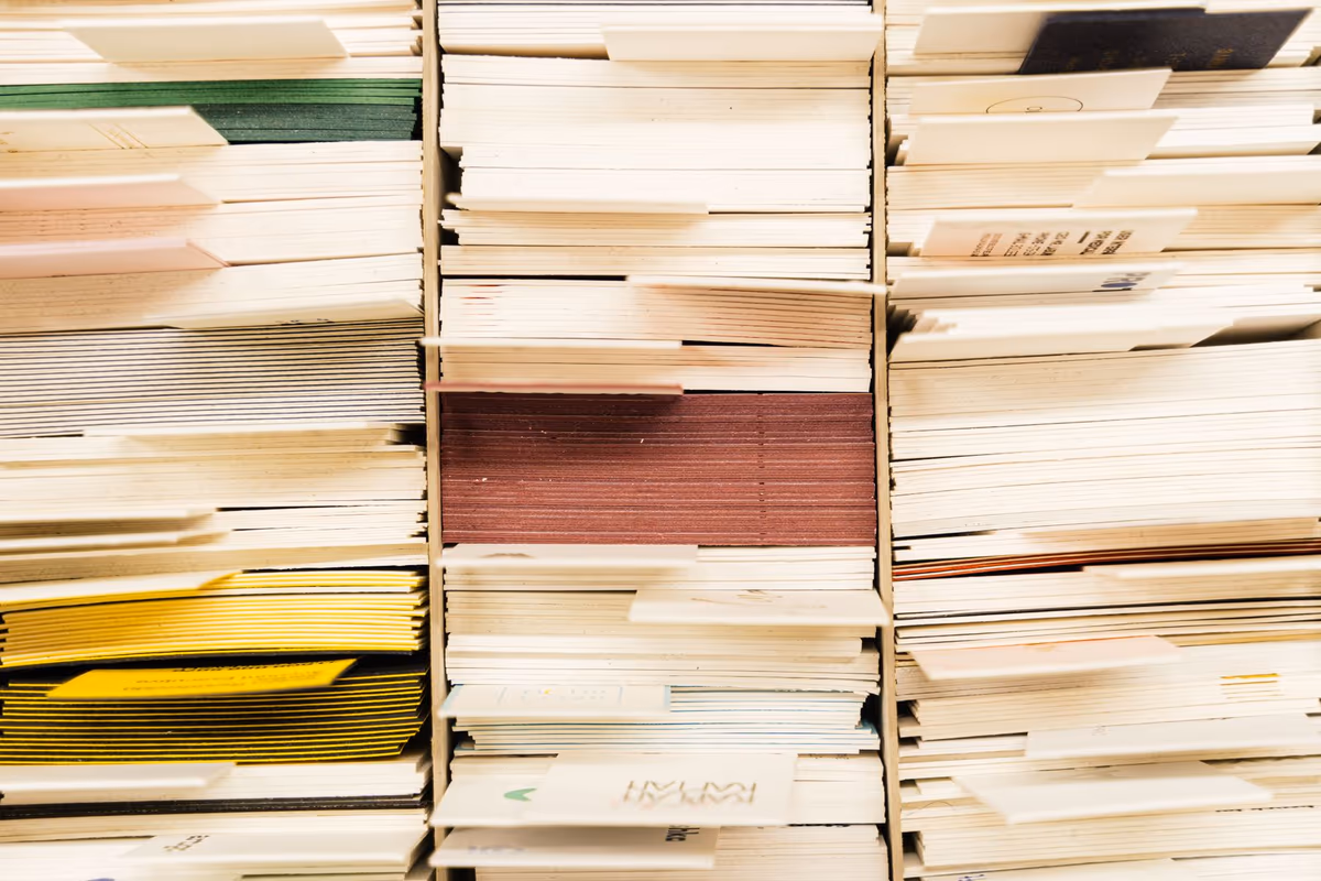 Liasses de documents administratifs empilées de chant, chemises et feuilles serrées en paquets distincts, vue rapprochée